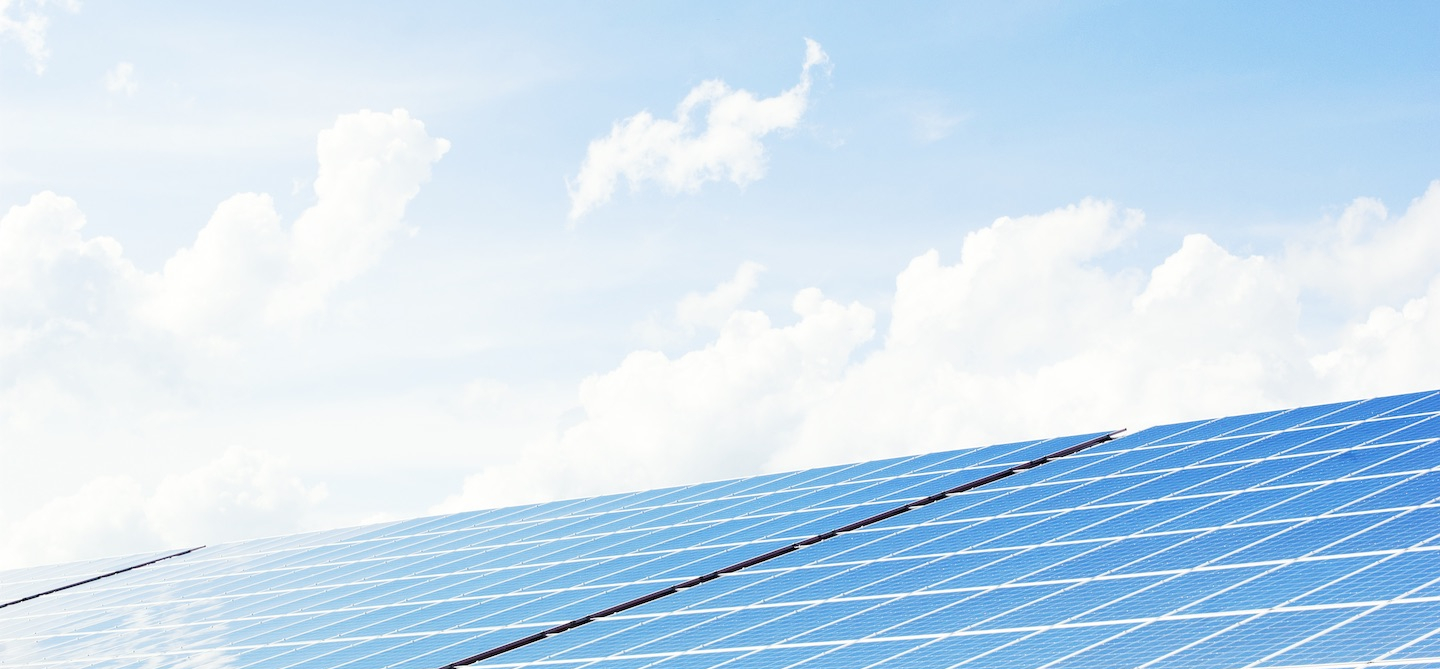 PV*SOL header image with blue sky, clouds and PV modules